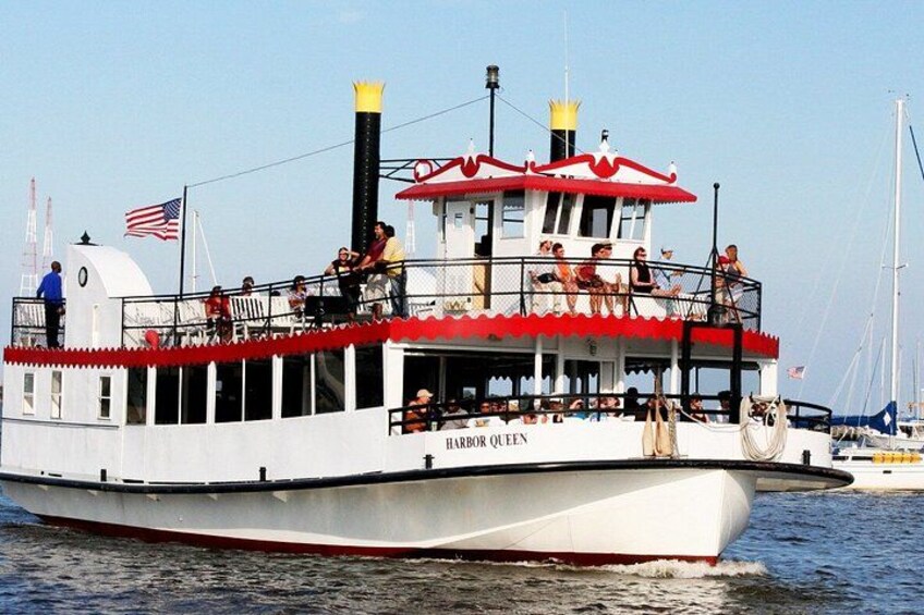 A white boat with red accents named 'Harbor Queen' on the water. 5
