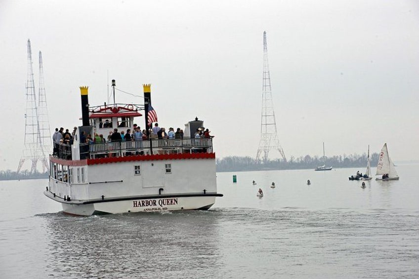 A ferry named Harbor Queen with passengers, sailing on a foggy day with a radio tower in the background. 3