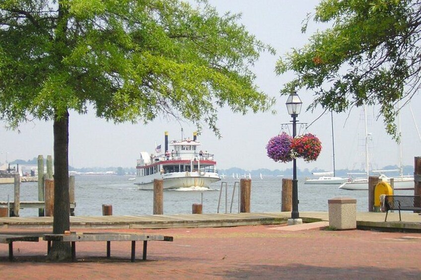 A river with a boat, wooden posts, a bench, and a lamppost. 4