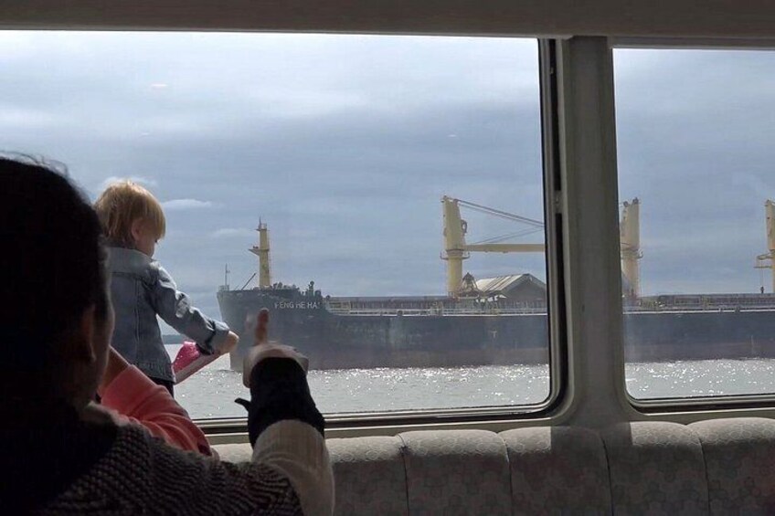 A ferry with a bridge in the background. 4
