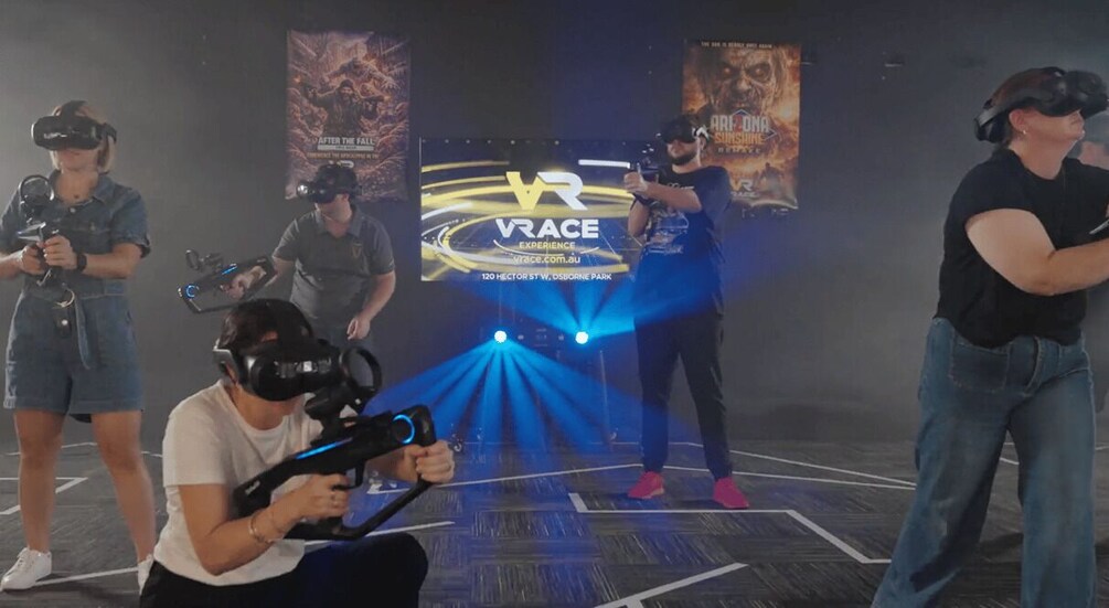 People using VR headsets in a gaming setup with a VR experience banner. 3