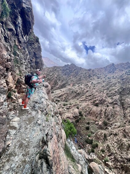 A hiker on a rocky mountain trail. 5