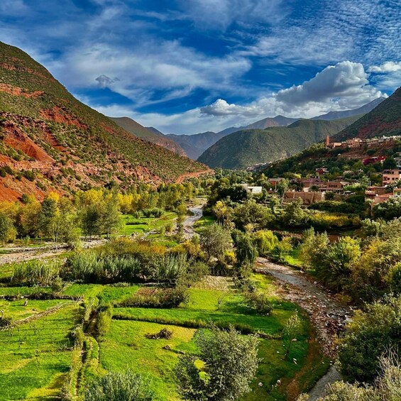A valley with terraced fields, a river, and a village on a hillside. 4