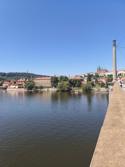 A river with a bridge, a tall monument, and buildings in the background. 5