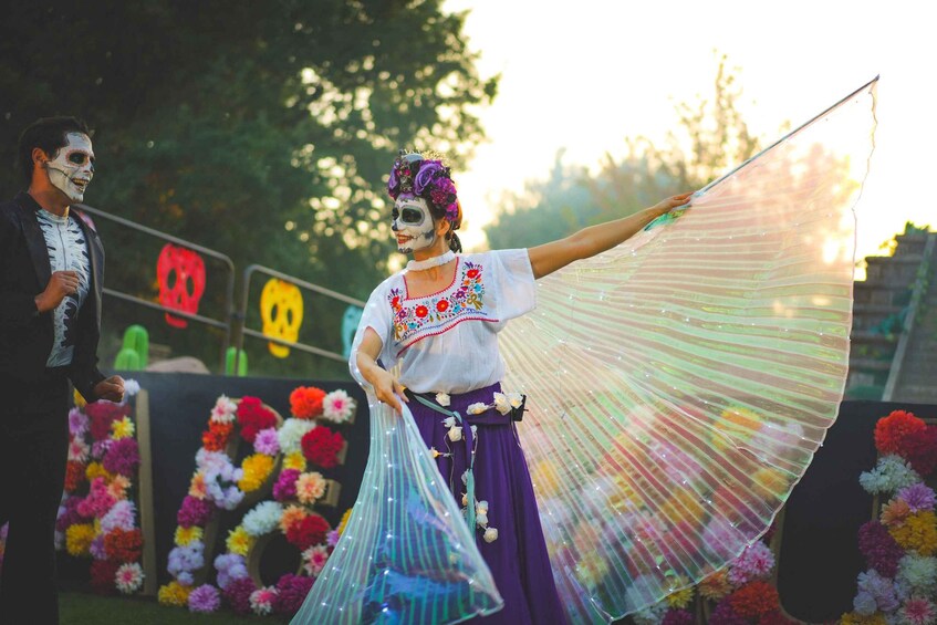 A person holding a translucent fabric, possibly a fan, with a floral background and a sign with a skull and crossbones. 4