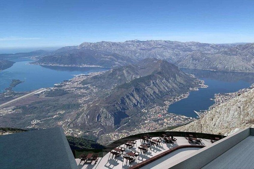 A mountainous landscape with a lake, a town, and a ski lift. 5
