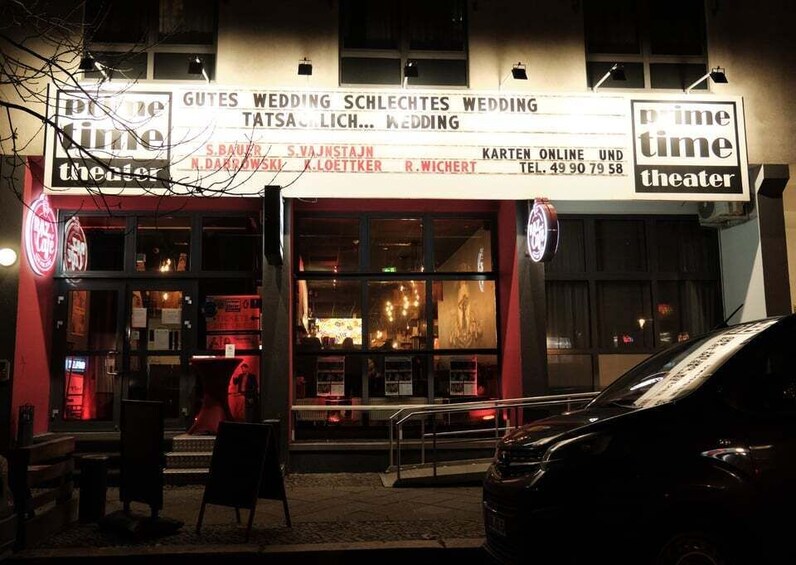 A theater with a marquee advertising weddings. 5
