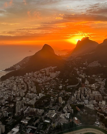 A cityscape with a mountain range during sunset. 3