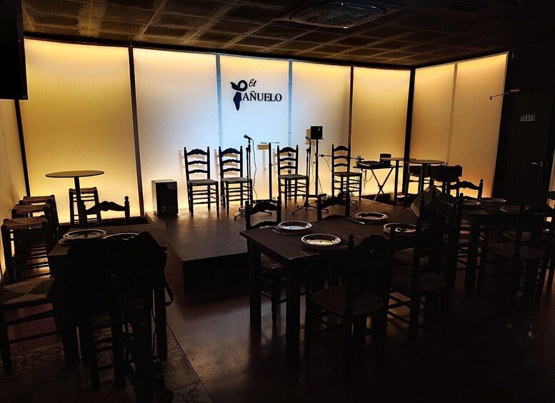 A restaurant interior with tables, chairs, and a wall with the logo 'El Añejo'. 5