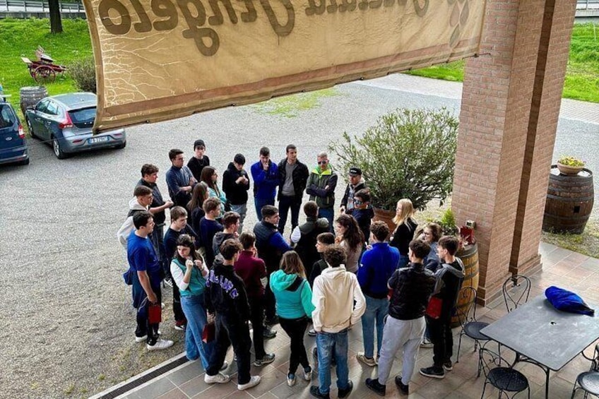A group of people gathered under a tent with a banner. 2