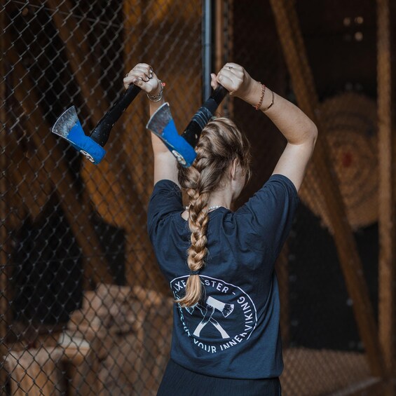 A person with a braided ponytail holding a hammer. 4