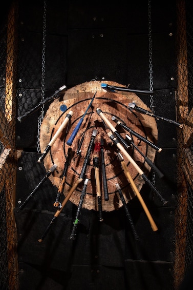 A collection of tools, including hammers and axes, arranged on a wooden surface. 3
