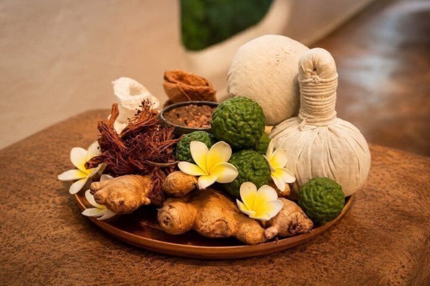 A plate with ginger, green tea leaves, and a bottle of oil. 3