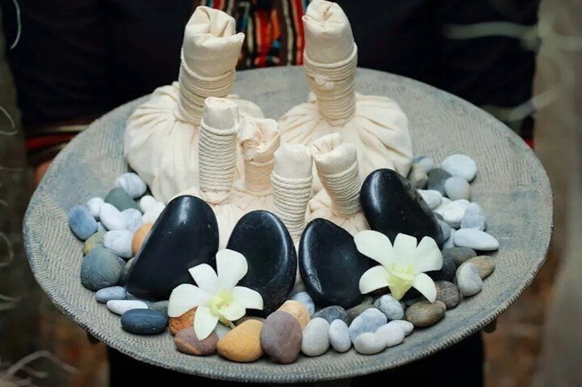 A stone arrangement with flowers and a plate. 4