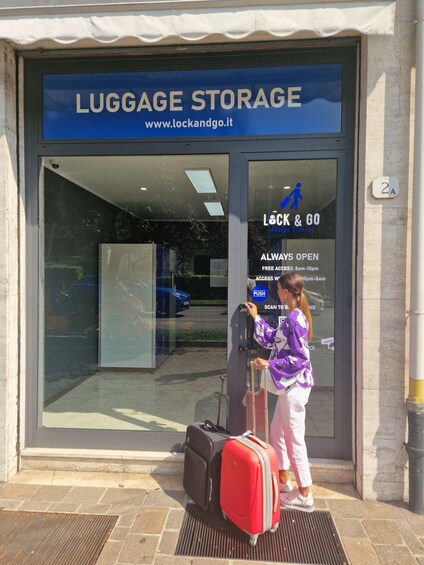 A luggage storage facility with a blue sign and a glass door. 2