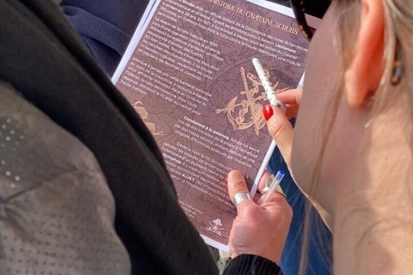 A person reading a book with a pen. 5