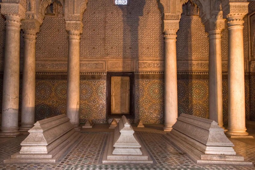 A courtyard with columns, patterned walls, and a central door. 2