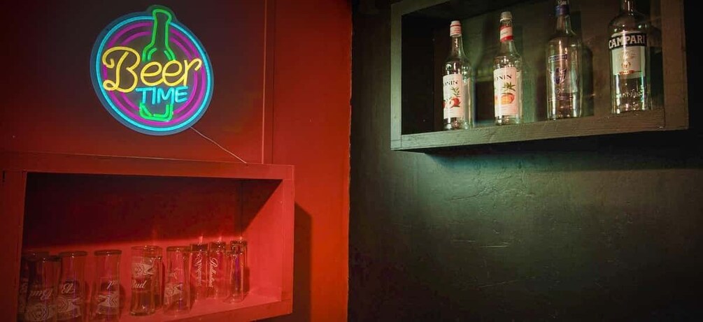 A neon sign reading 'Beer Time' and a shelf with bottles and glasses. 2