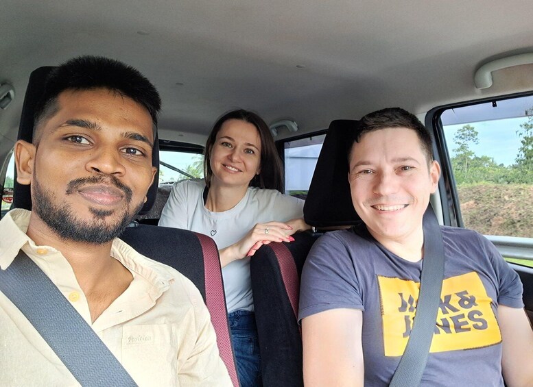 Three people seated in a vehicle with a seatbelt. 2