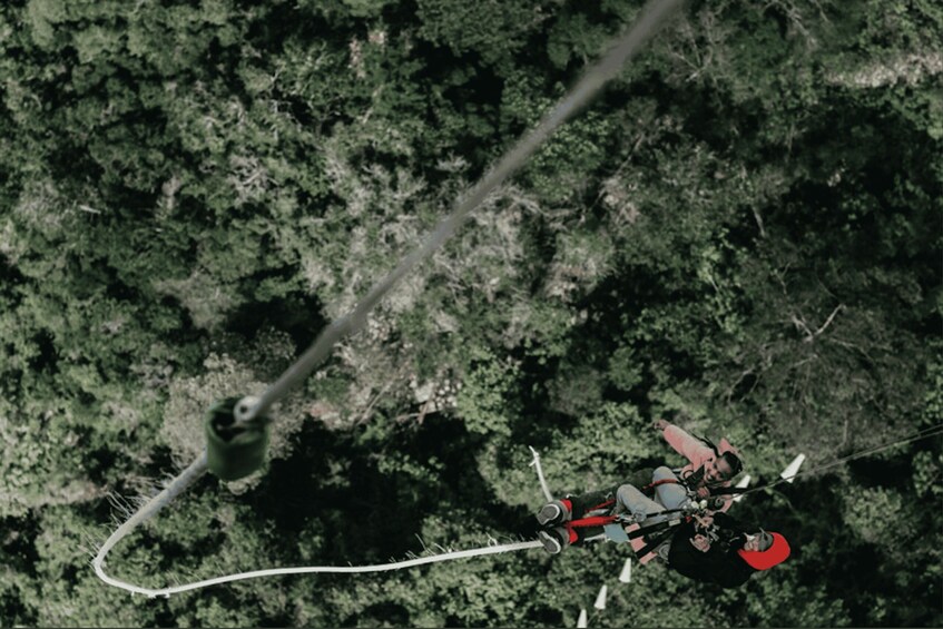 A person bungee jumping from a high point with a safety harness and a bungee cord. 2