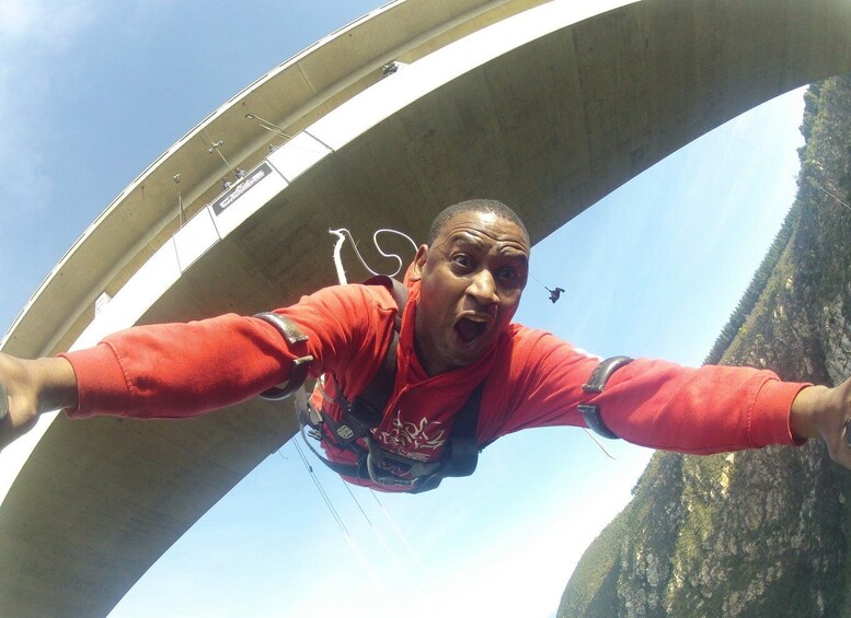 A person bungee jumping from a bridge. 5
