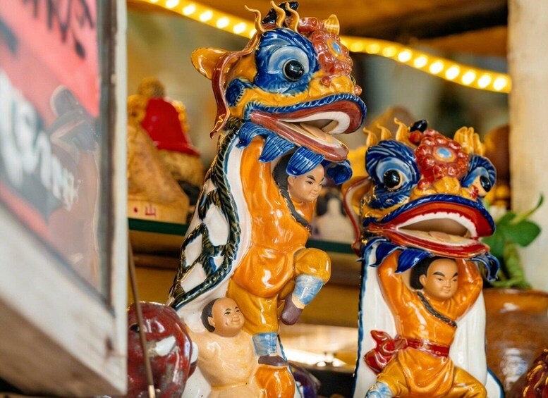 A dragon statue with a child figure beside it. 5