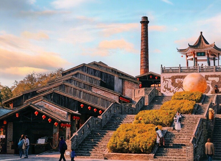 A traditional Chinese building with a large chimney, a pagoda-style structure, and a staircase leading up to a platform with a large spherical decoration. 2