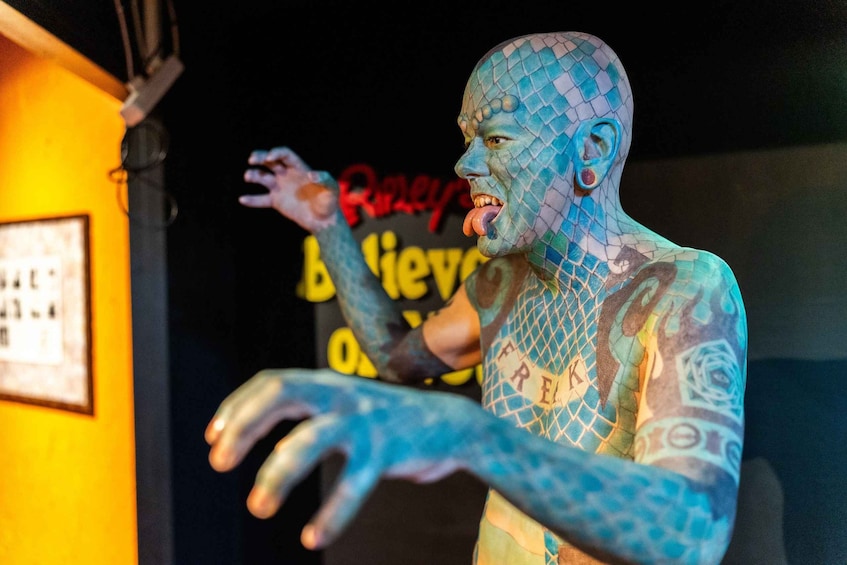 A person with blue body paint and tattoos. 1