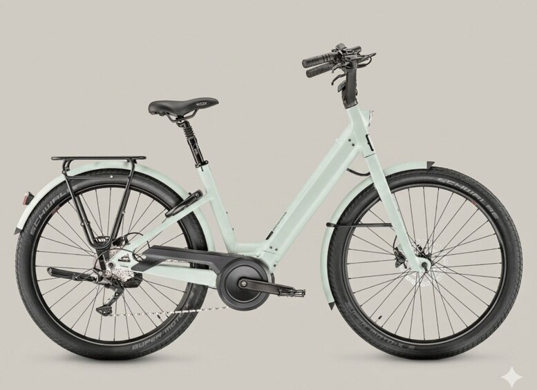 A stationary electric bicycle with a light blue frame, black seat, and rear rack. 3