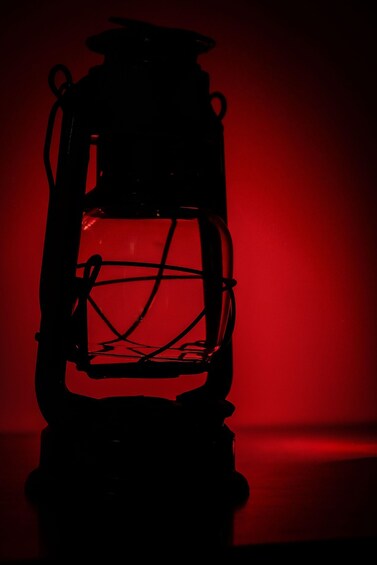 A silhouette of a lantern against a red background. 4