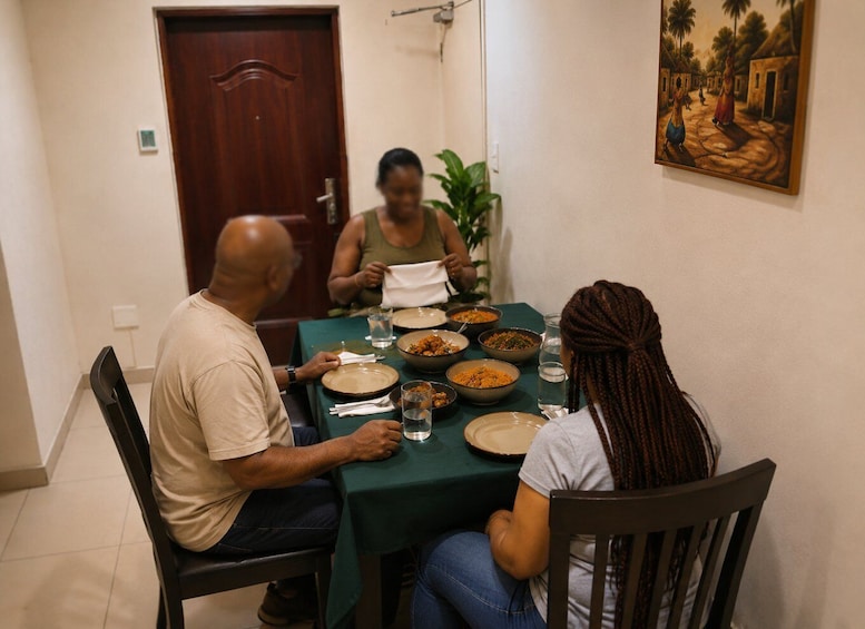 A dining table with multiple dishes, a door, and a painting on the wall. 2