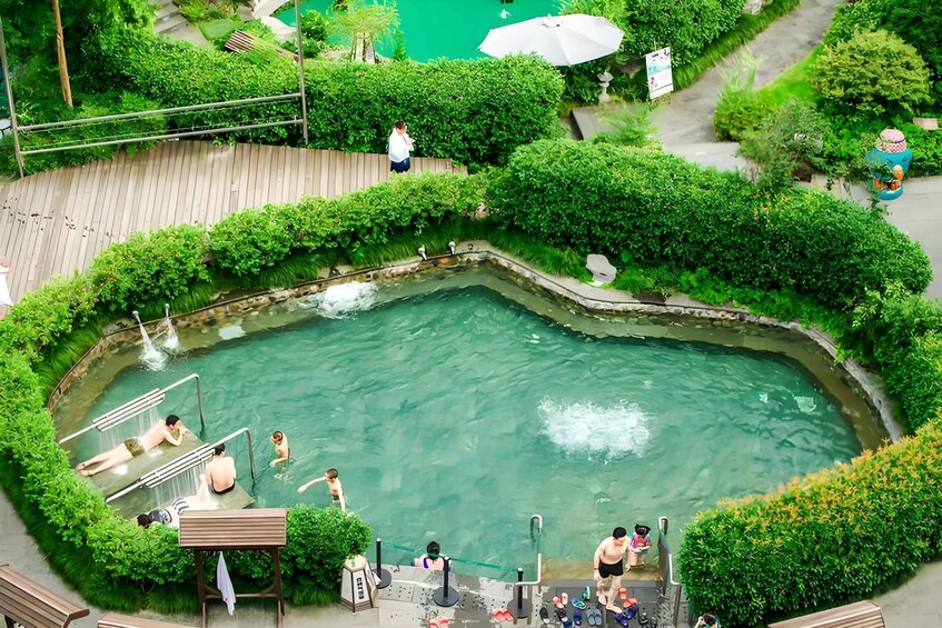 A hot spring with people swimming and relaxing. 2
