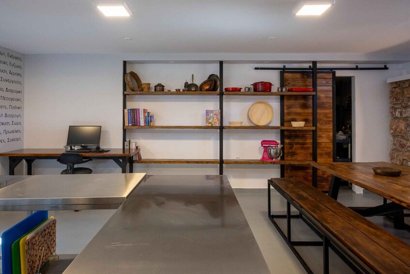 A modern kitchen with wooden shelves, a dining table, and a kitchen island. 5