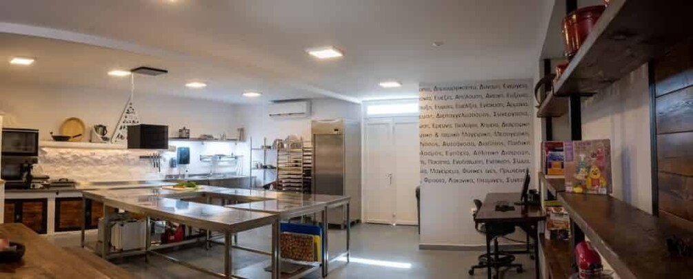 A modern kitchen with stainless steel appliances, a large island, and wooden cabinets. 1