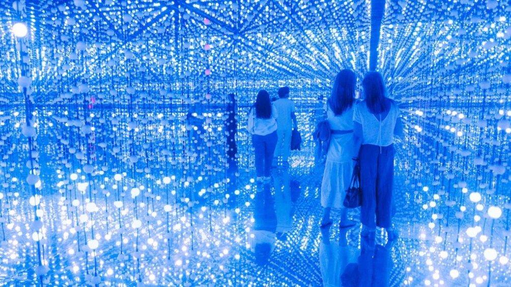 A tunnel of blue lights with people walking through. 3