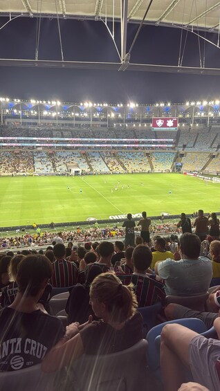 A stadium filled with spectators watching a soccer match. 2