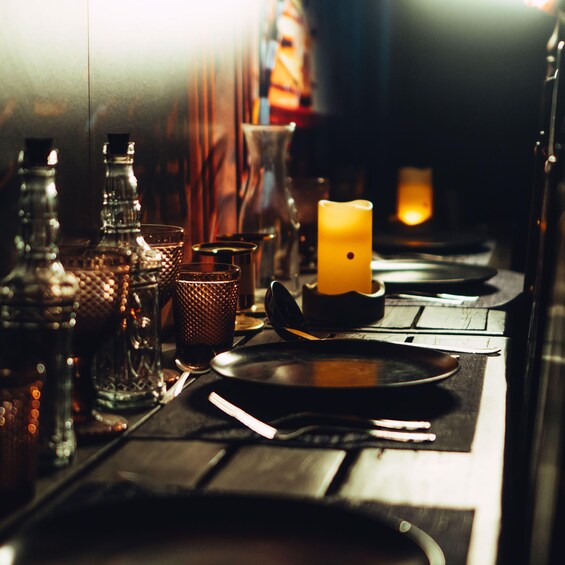 A table set with plates, cutlery, and a candle. 5