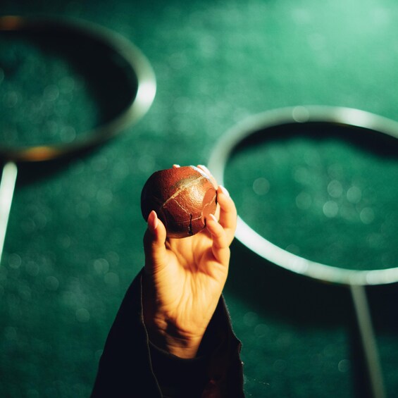 A hand holding a basketball. 4
