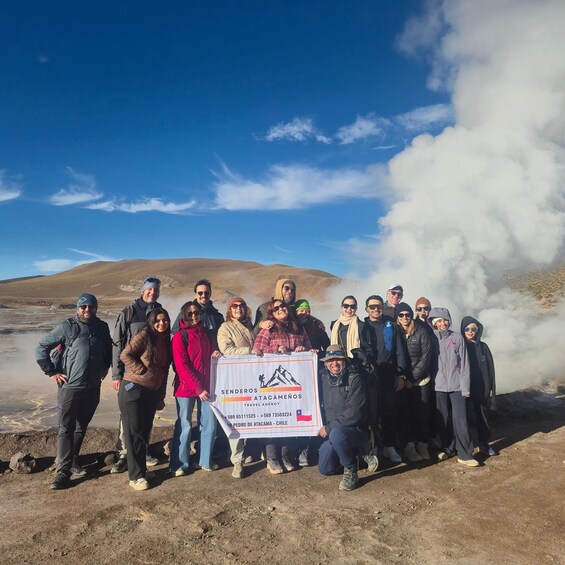 A group of people standing in a dry, hilly landscape with a clear sky. 5