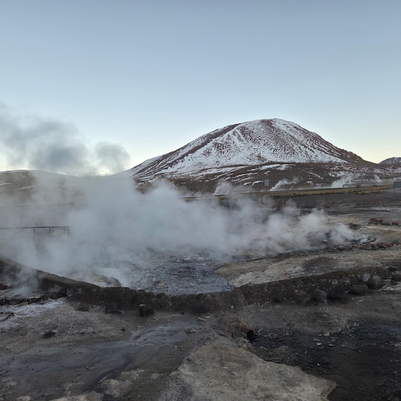 A snow-covered mountain with steam rising from the ground. 5