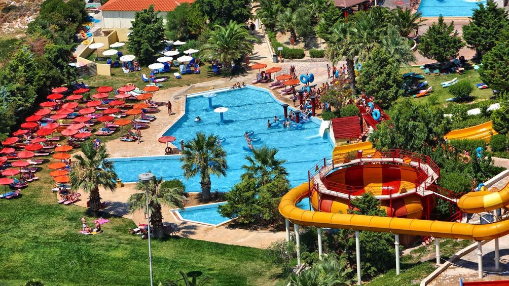 A water park with multiple pools, slides, and umbrellas. 4