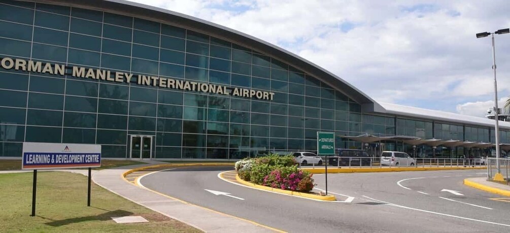 An airport terminal with a sign for the Learning & Development Centre. 1