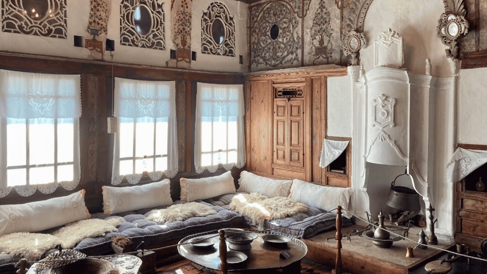 A traditional room with ornate wooden furniture, a fireplace, and decorative wall panels. 4