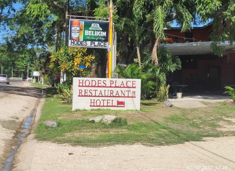 A sign for Hodes Place Restaurant and Hotel with a Belikin advertisement. 3