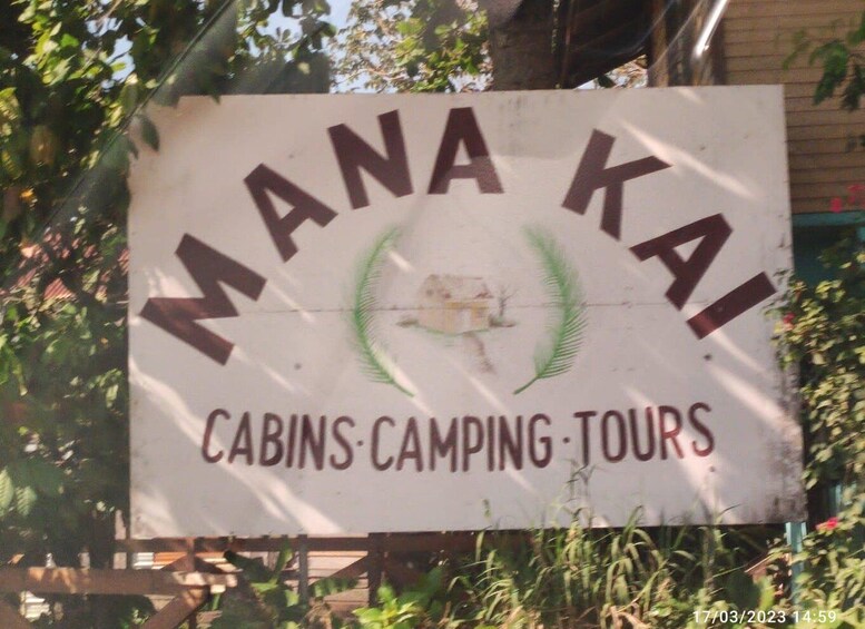 A sign for Mana Kai, offering cabins, camping, and tours. 4