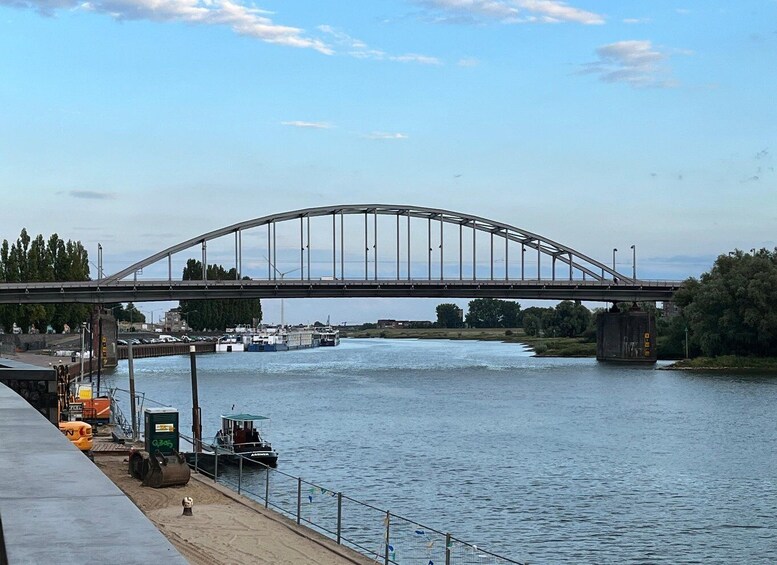 A river with a bridge, boats, and construction equipment. 1