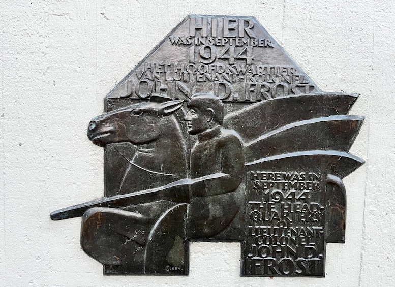 A memorial plaque with inscriptions and a horse figure. 2
