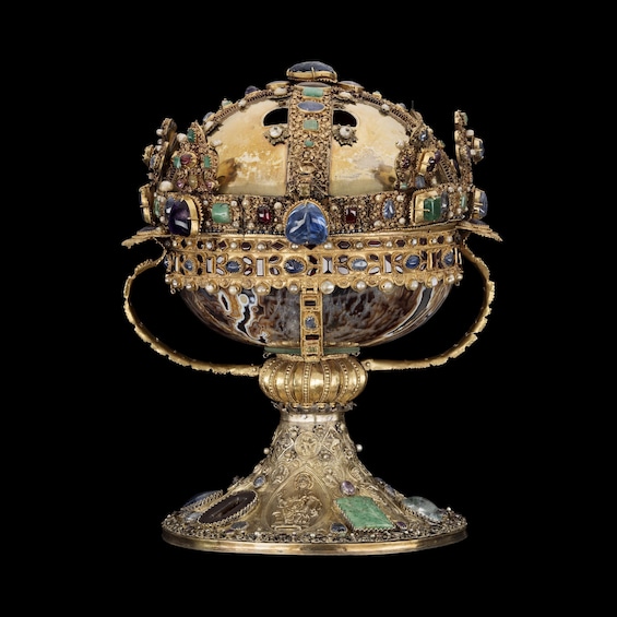 A detailed, ornate golden bowl with intricate designs and embedded gemstones. 2