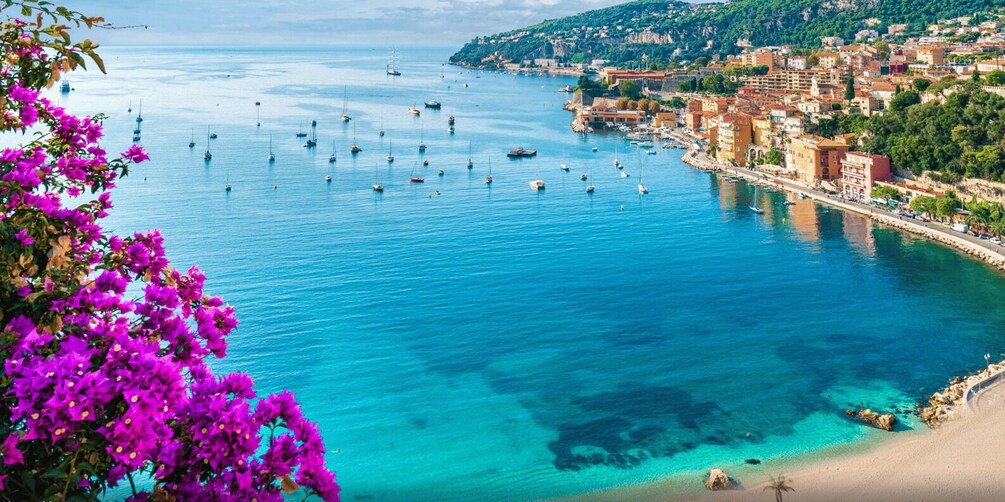 A coastal town with clear blue waters, boats, and colorful buildings. 3