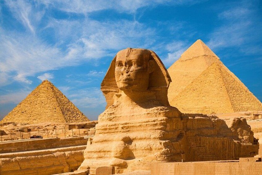 The Great Sphinx and two pyramids in the background. 1